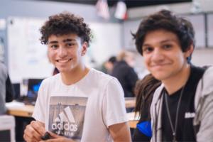 Two high school students smiling.